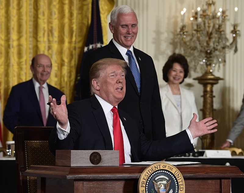 President Donald Trump gestures as he signs a "Space Policy Directive" during a meeting of the National Space Council in the East Room of the White House, Monday, June 18, 2018, in Washington, as Vice President Mike Pence watches.  AP Photo/Susan Walsh)