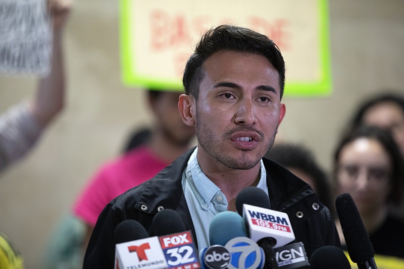 Antonio Gutierrez speaks during a protest announcing a federal class-action lawsuit filed against the city by several community groups, alleging that officers, given "unlimited" discretion to add individuals to the department's massive gang database, often falsely label people as gang members "based solely on their race and neighborhood," Tuesday, June 19, 2018, at City Hall in Chicago. Four men who say they have been inaccurately labeled gang members by Chicago police were joined by members of various community groups at the protest. (Erin Hooley/Chicago Tribune via AP)