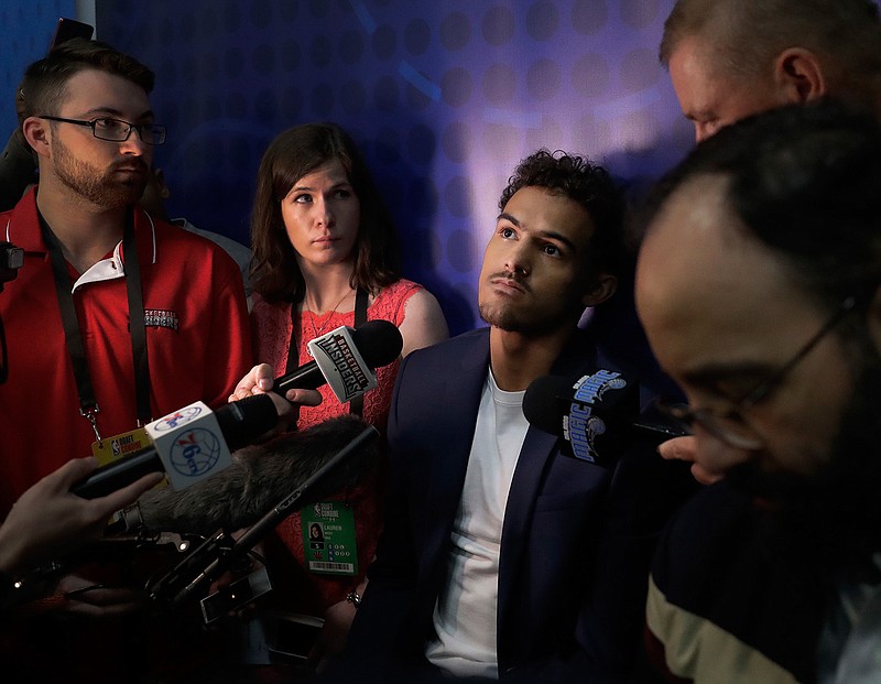 Trae Young, center, from Oklahoma University, listens to a question during the interview segment of the NBA draft basketball combine on May 18 in Chicago. This is where the interviews happen for the draft, where teams meet players and ask them about everything from their family histories to their thoughts on highway safety before investing millions of dollars.