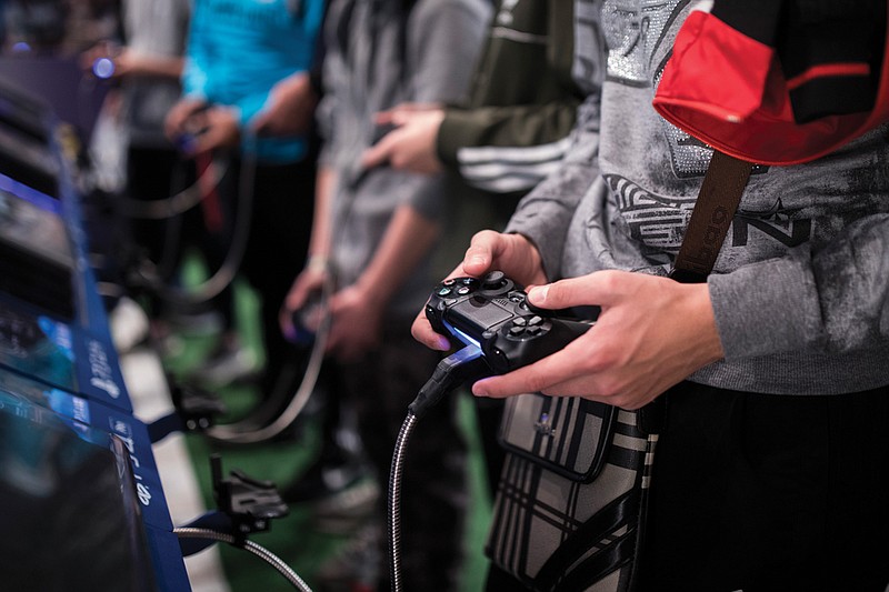 A man plays a game Nov. 3, 2017, at the Paris Games Week in Paris. The World Health Organization says that compulsively playing video games now qualifies as a new mental health condition.