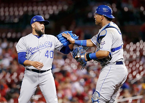 Royals relief pitcher Kelvin Herrera and catcher Salvador Perez celebrate following a 5-1 win against the Cardinals last month at Busch Stadium. Herrera was dealt Monday to the Nationals.