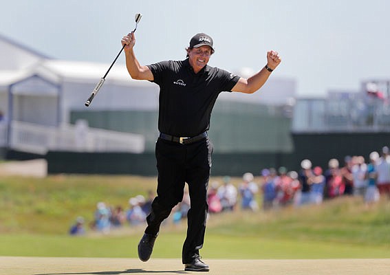 Phil Mickelson reacts after sinking a putt on the 13th hole during Sunday's final round of the U.S. Open in Southampton, N.Y.