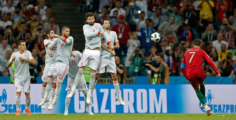 Portugal's Cristiano Ronaldo scores his third goal with a free kick during the group B World Cup match between Portugal and Spain on Friday at Fisht Stadium in Sochi, Russia.