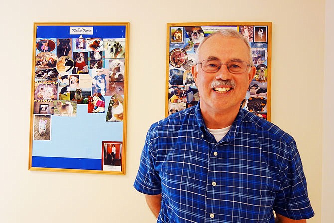 Dr. Bruce Robertson retired from Midwest Veterinary Clinic on Friday after 35 years of taking car of Fulton's pets. Some of those pets can be seen on the wall behind him.