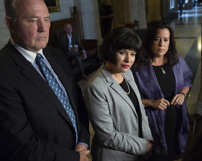 Minister of Justice and Attorney General of Canada Jody Wilson-Raybould, right, Minister of Health Ginette Petitpas Taylor, center, and Parliamentary Secretary to the Minister of Justice and Attorney General of Canada and to the Minister of Health Bill Blair, left, listen to questions during a press conference on Bill C-45, the Cannabis Act, in the Foyer of the House of Commons on Parliament Hill in Ottawa, Ontario on Wednesday, June 20, 2018. The Canadian government said it will soon announce the date of when cannabis will become legal,  but warns it will remain illegal until then. (Justin Tang/The Canadian Press via AP)