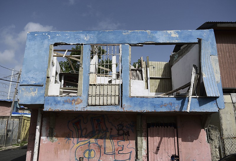 In this June 13, 2018 photo, a residence in the Figueroa neighborhood stands destroyed nine months after Hurricane Maria, in San Juan, Puerto Rico. While the Department of Housing channels millions in federal funds through the "Tu Hogar Renace" program to repair homes affected by the storm, there are still thousands of homes that are in need for repairs. (AP Photo/Carlos Giusti)