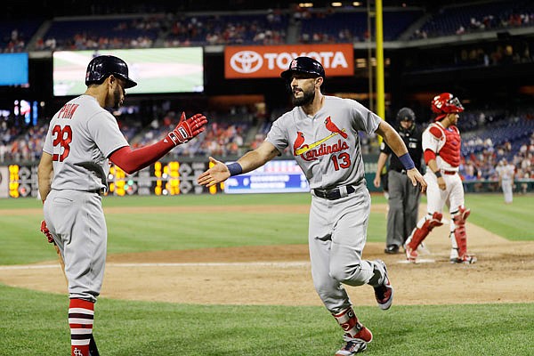 Matt Carpenter of the Cardinals celebrates with Tommy Pham after Carpenter's solo home run in the top of the ninth inning Tuesday night against the Phillies in Philadelphia.