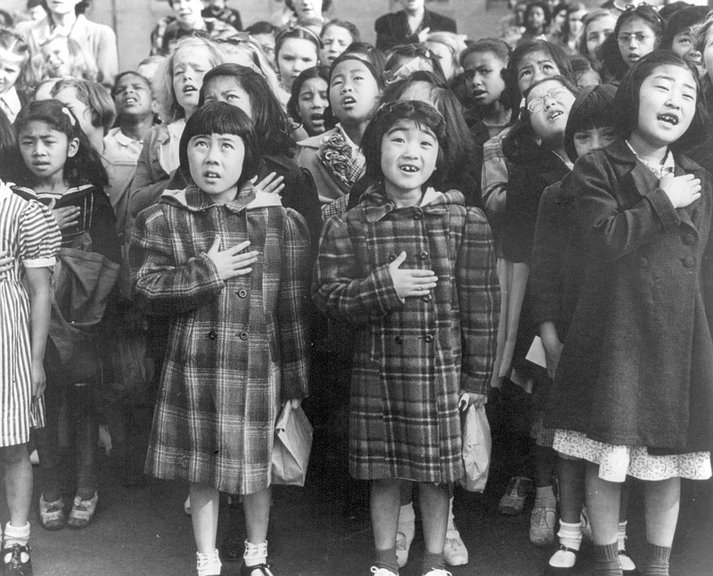 In this April 1942 file photo made available by the Library of Congress, children at the Weill public school in San Francisco recite the Pledge of Allegiance. Some of them are evacuees of Japanese ancestry who will be housed in War Relocation Authority centers for the duration of World War II.