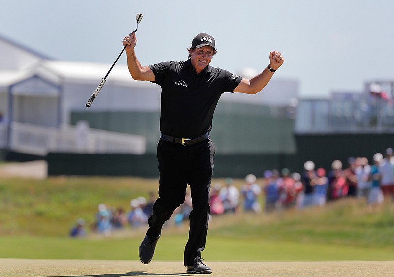 In this June 17, 2018, file photo, Phil Mickelson reacts after sinking a putt on the 13th hole during the final round of the U.S. Open Golf Championship, in Southampton, N.Y. Mickelson brought attention to a tough setup on Saturday when he intentionally hit a putt with the ball still rolling and was penalized. (AP Photo/Frank Franklin II, File)