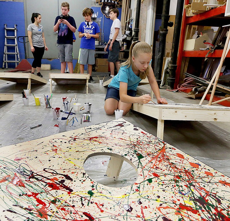 In this Wednesday, June 13, photo-Brooke Griffin, age 11, works on her cornhole project during summer camp at Maker's Edge Makerspace in downtown Waco, Wednesday, June 13, 2018, in Waco, Texas. Campers used an assortment of tools and material during the building stage of their gaming week. (Rod Aydelotte/ Waco Tribune Herald via AP)
