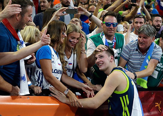 In this Sept. 14, 2017, file photo, Slovenia's Luka Doncic celebrates with fans at the end of a Eurobasket European Basketball Championship semifinal game against Spain in Istanbul.