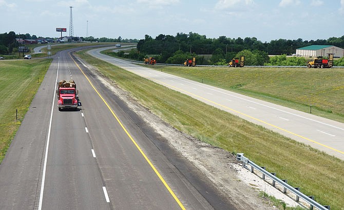 A convoy of striping trucks moves onto U.S. 54 from Route H on Wednesday afternoon, well marked for the task at hand. MoDOT officials said drivers should be alert for slow-moving vehicles as they mow, stripe and repair guardrails throughout the state this summer.