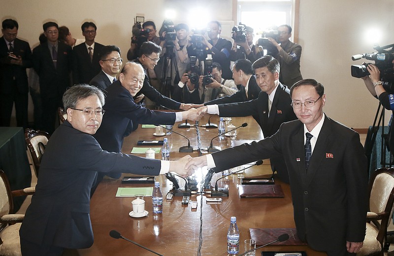 In this photo provided by South Korea Unification Ministry, South Korean Red Cross President Park Kyung-seo, second from left, shakes hands with his North Korean counterpart Pak Yong Il during a meeting at Diamond Mountain resort in North Korea, Friday, June 22, 2018. North and South Korean officials met Friday for talks on resuming reunions of families divided by the 1950-53 Korean War as the rivals boost reconciliation amid a diplomatic push to resolve the North Korean nuclear crisis. (South Korea Unification Ministry via AP)