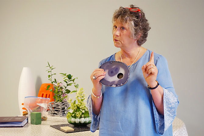 Columbia-based flower show judge Carolyn Oates said a candle holder like this one could make an unexpected, fun base for a design entry. Two examples of her designs can be seen in the background.