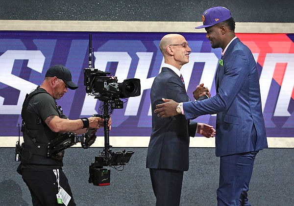 Arizona's Deandre Ayton shakes hands with NBA commissioner Adam Silver on Thursday after he was picked first overall by the Suns during the NBA draft in New York.