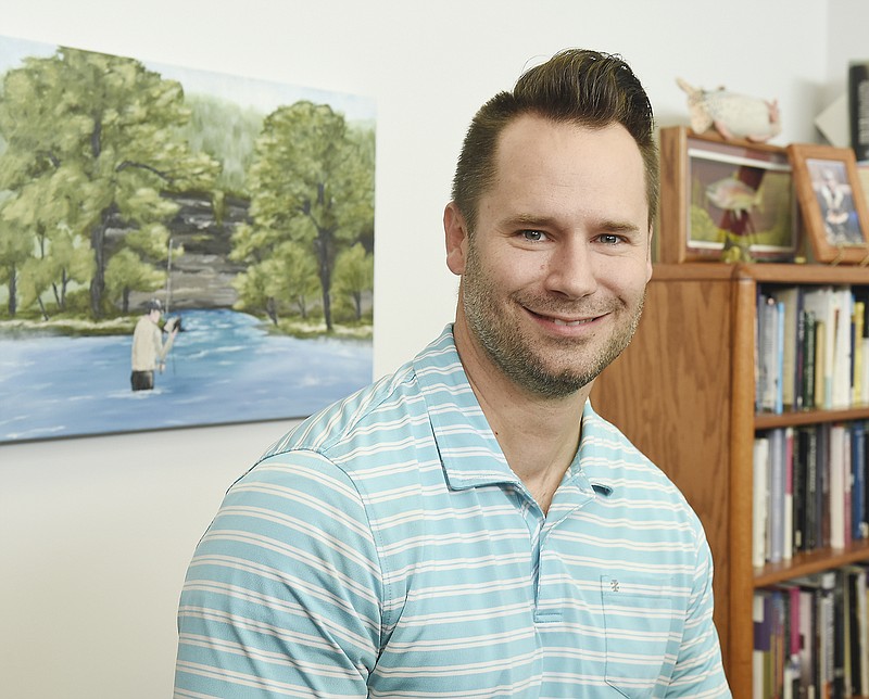 Jacob Taggart poses Wednesday in his office at Concord Baptist Church annex. Taggart is the author of "Theology from the Spring: Reflections of the Creator Cast in Nature."