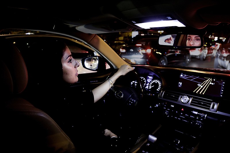 Hessah al-Ajaji drivers her car down the capital's busy Tahlia Street after midnight for the first time in Riyadh, Saudi Arabia, Sunday, June 24, 2018. Saudi women are in the driver's seat for the first time in their country and steering their way through busy city streets just minutes after the world's last remaining ban on women driving was lifted on Sunday. (AP Photo/Nariman El-Mofty)