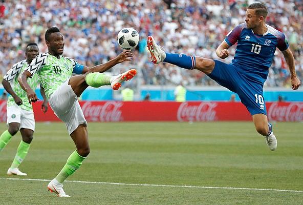 Nigeria's John Obi Mikel (left) and Iceland's Gylfi Sigurdsson compete for the ball Friday during a Group D match in Volgograd, Russia.