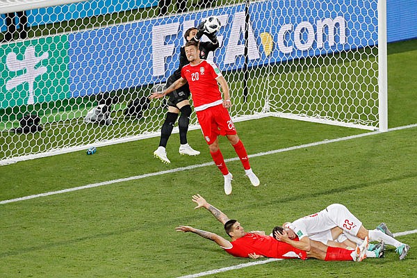 Switzerland goalkeeper Yann Sommer and Serbia's Sergej Milinkovic-Savic battle for a high ball Friday during a Group E match in Kaliningrad, Russia.