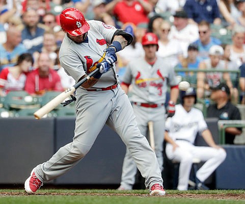 Yadier Molina of the Cardinals hits a two-run home run during the sixth inning of Saturday's game against the Brewers in Milwaukee.