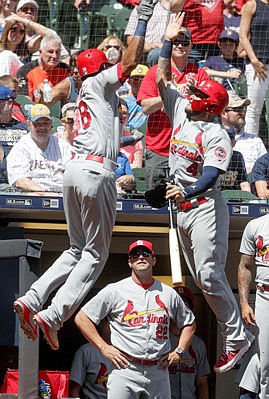 Jose Martinez of the Cardinals celebrates his three-run home run with Yadier Molina during the fourth inning of Sunday's game against the Brewers in Milwaukee.