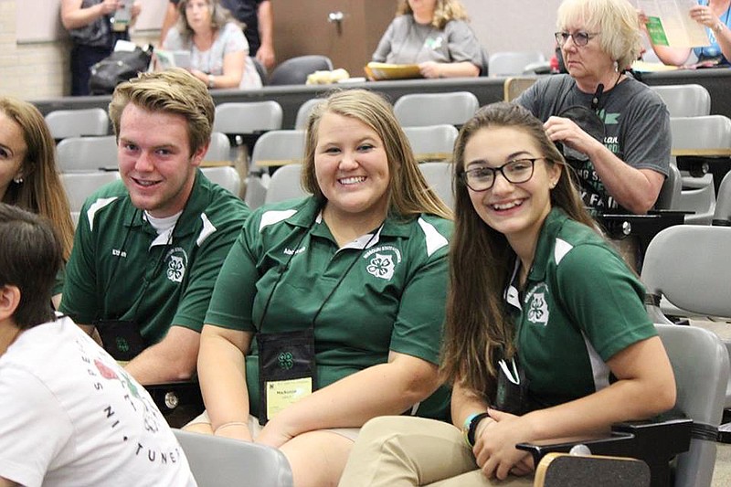 MacKenzie Loesch sits between 2017-18 East Central Regional Representatives Ethan Walker and Kaitlyn Walmper at the 73rd annual State 4-H Congress in Columbia.