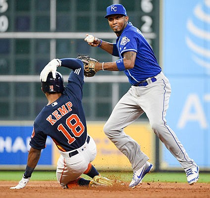 Royals shortstop Alcides Escobar turns a double play above a sliding Tony Kemp of the Astros during the fifth inning of Sunday's game in Houston.