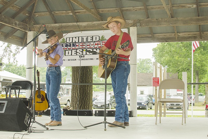 Sophia Schindler, left, plays the fiddle while Ethan Schindler plays the guitar to accompany her Sunday, June 24, 2018, during the Plly Burre Memorial Old Time Fiddler's Contest in Tebbetts, Mo. Ethan later won the youth division of the contest for his fiddle performance.