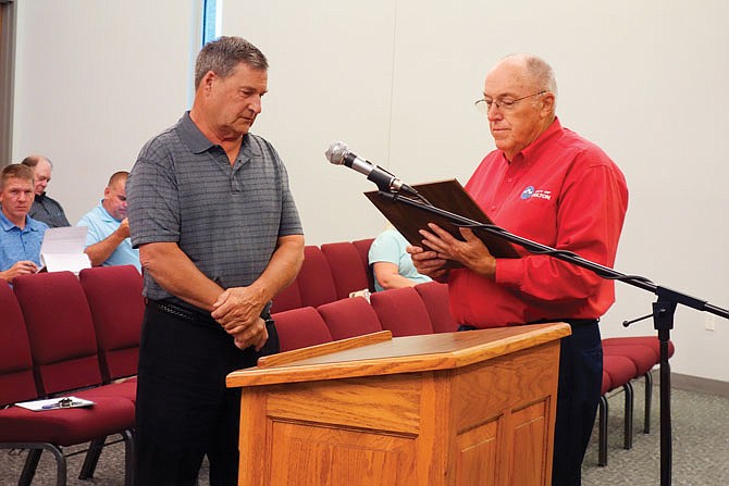 J.C. Miller, left, is leaving his job at the city after decades. On Tuesday, Mayor LeRoy Benton gave him a plaque recognizing his 27 years, 11 months and 29 days of employment. Miller started working for the city as a solid waste foreman on July 1, 1990, and moved up the ranks. His last promotion, on March 6, 2000, was to solid waste manager.