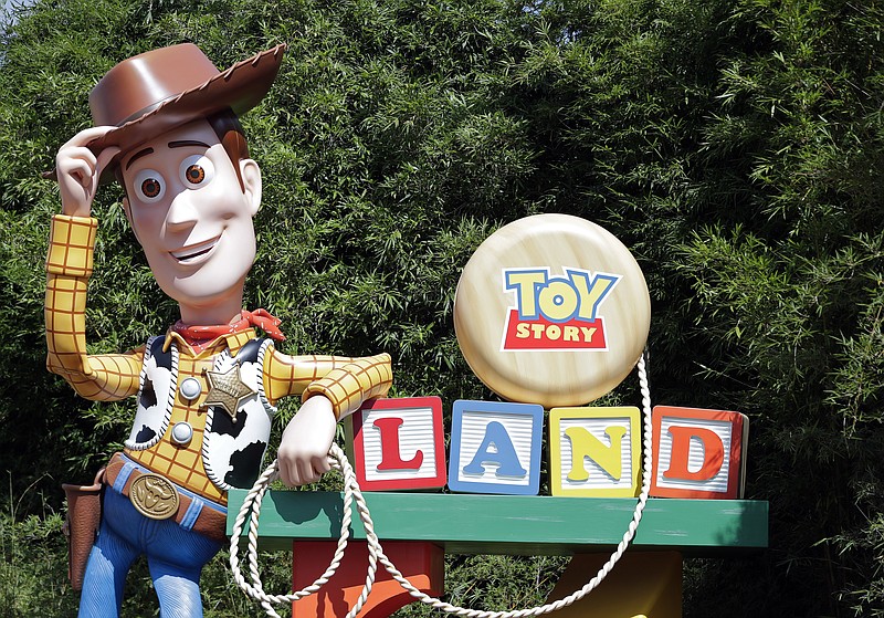 In this Saturday, June 23, 2018 photo, a statue of the character Sheriff Woody greets visitors at the entrance Toy Story Land in Disney's Hollywood Studios at Walt Disney World in Lake Buena Vista, Fla. (AP Photo/John Raoux)