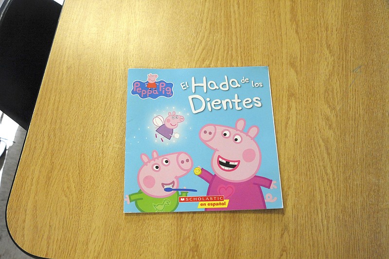 <p>Michelle Brooks/For the News Tribune</p><p>Moniteau County Head Start’s bilingual program includes books like “Peppa Pig: El Hada de los Dientes,” which is read and discussed in Spanish.</p>