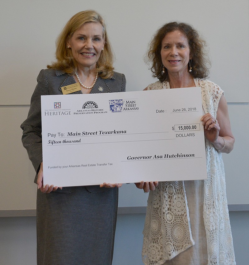 Ina McDowell, right, Main Street Texarkana's executive director, accepts a grant for $15,000 from the Arkansas Historic Preservation Program. (Submitted photo)
