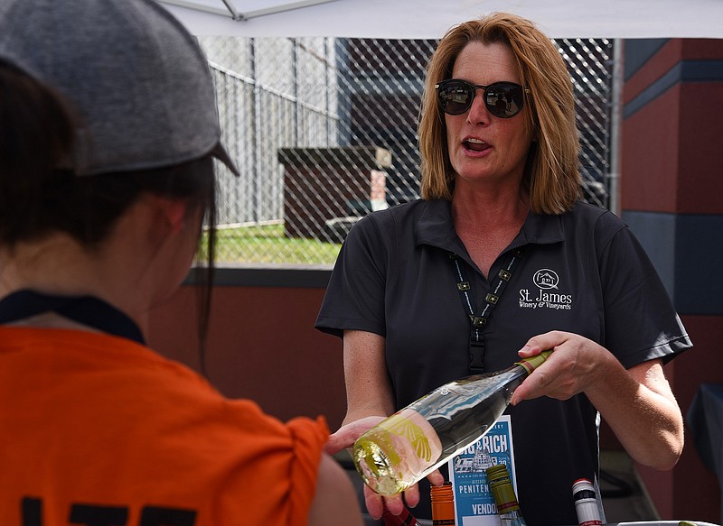 Beth Hofherr explains the blend of fruit and flavor at the St. James Winery tent during the Inside The Walls concert series at the Missouri State Penitentiary on Saturday, June 30, 2018. Attendees had the opporunity to participate in a raffle and enjoy food vendors and drinks throughout the day.