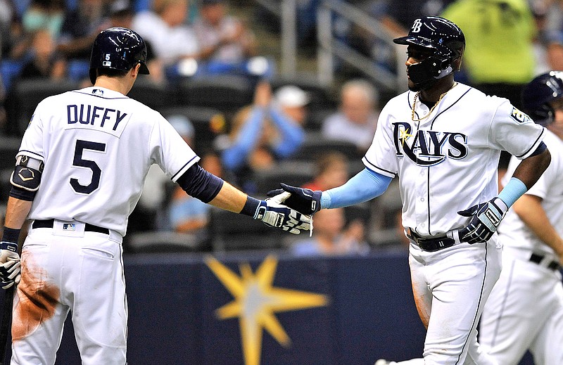 Tampa Bay Rays on deck-batter Matt Duffy (5) congratulates Adeiny Hechavarria, who scored from second base on a throwing error by Houston Astros shortstop Marwin Gonzalez during the fourth inning of a baseball game Friday, June 29, 2018, in St. Petersburg, Fla. (AP Photo/Steve Nesius)