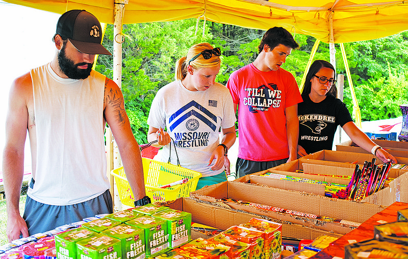 From left, Brad Thomas, Tori McNutt, Ben Thomas and Natalie Falotico shop for fireworks Sunday at Eastside Fireworks.