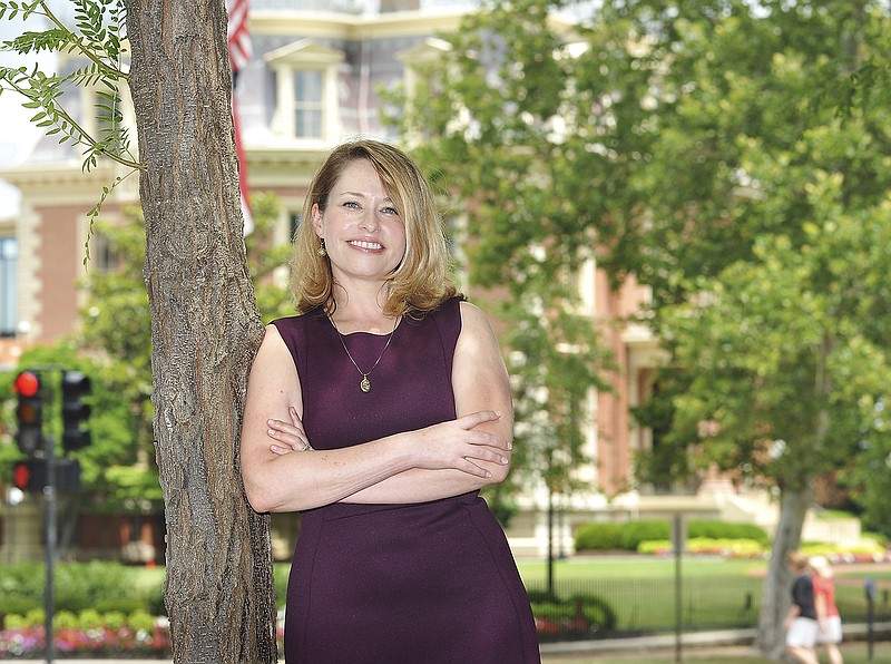 With the Governor's Mansion as a backdrop, Rebecca Gordon, executive director of Friends of the Missouri Governor's Mansion, poses for a portrait.