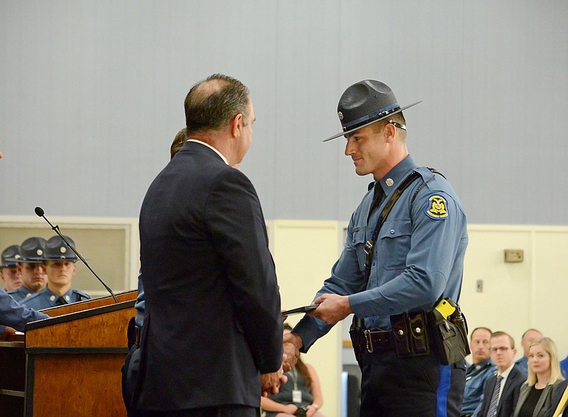 Jacob McKinney, of Tebbetts, accepts his degree Friday during the Missouri Highway Patrol Commissioning at the Academy gymnasium. McKinney is one of 26 graduates who began the 25-week program Jan. 3. 