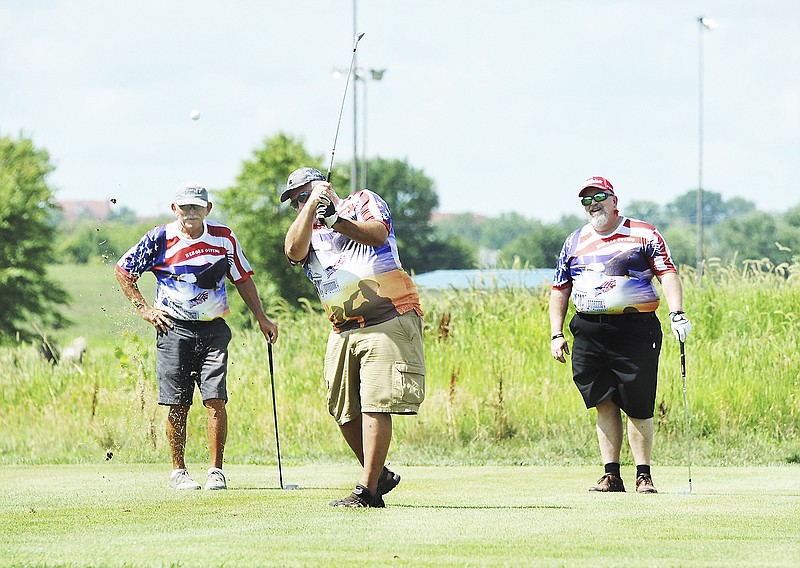 Several dozen area military veterans, including Jesse Cox, at right, Jeff Simpkins, middle, both Army veterans, were treated to a no-charge outing of golf and/or fishing Monday at Turkey Creek Golf Center as area planners hosted the first-time event called Heroes Outing. At left is David Keller, who works at the course and joined the group for nine holes. 