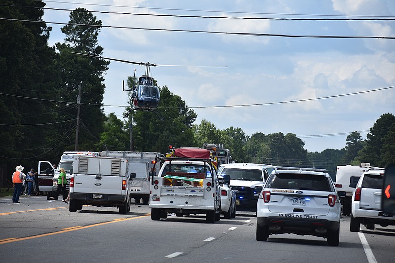 Emergency vehicles block a portion of U.S. Highway 71 on the north side of Ashdown so a helicopter can land and take off on Wednesday afternoon, July 4, 2018. Two died in a traffic accident and one was airlifted from the scene.