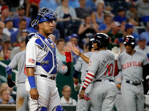 Royals catcher Salvador Perez stands at the plate while the Indians celebrate after a grand slam hit Yan Gomes during the sixth inning of Tuesday night's game at Kauffman Stadium in Kansas City.