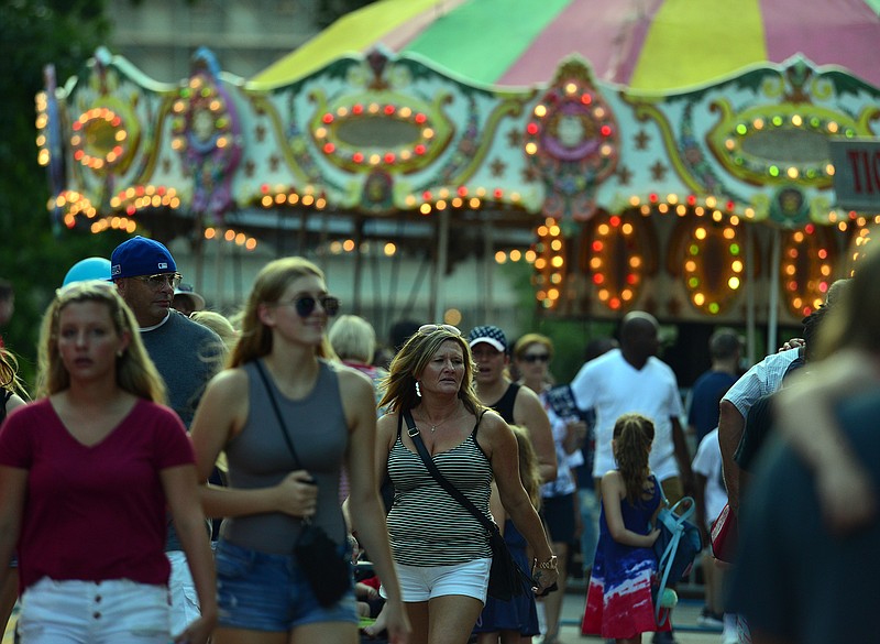 Families stroll through Salute to America Carnival Land in Jefferson City on the eve of Independence Day Tuesday, July 3, 2018.