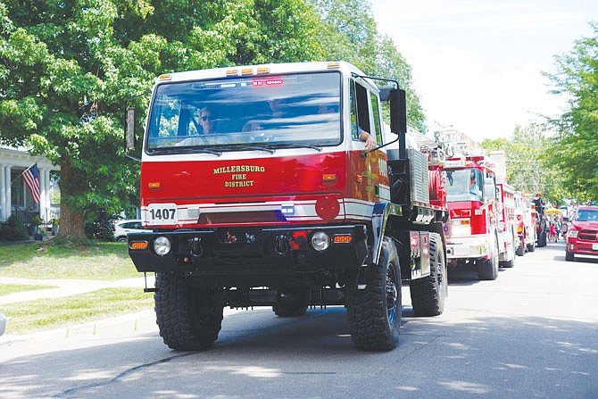 Millersburg firefighters lead a long line of first-responder vehicles in Wednesday's 4th of July parade in Fulton.