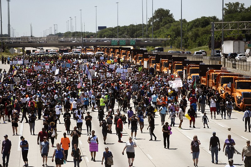 Protesters march on the Dan Ryan Expressway, Saturday, July 7, 2018, in Chicago. The protesters shut down the expressway in an attempt to increase pressure on public officials to address the gun violence that's claimed hundreds of lives in some of the city's poorest neighborhoods. (AP Photo/Annie Rice)