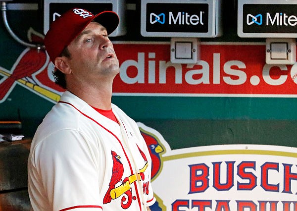 Cardinals manager Mike Matheny watches from the dugout during the sixth inning of a game last month against the Braves at Busch Stadium in St. Louis.