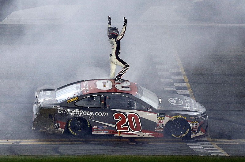 Erik Jones celebrates in front of fans after winning the NASCAR Cup Series auto race Saturday at Daytona International Speedway in Daytona Beach, Fla.