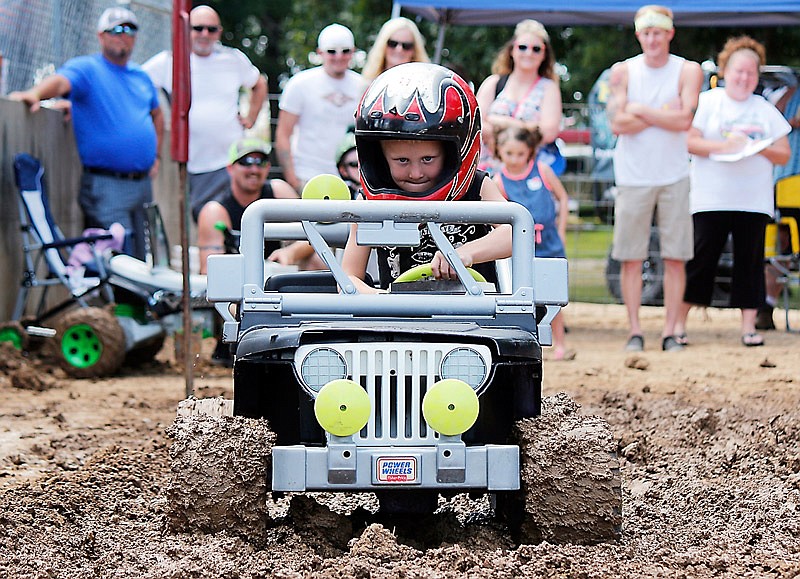 Carson Strope, 5, attempts to power through the mud with his 12-volt-battery-powered vehicle during the Power Wheels Mud Run at the Osage County Fair on Saturday, July 15, 2017 in Linn, Missouri.