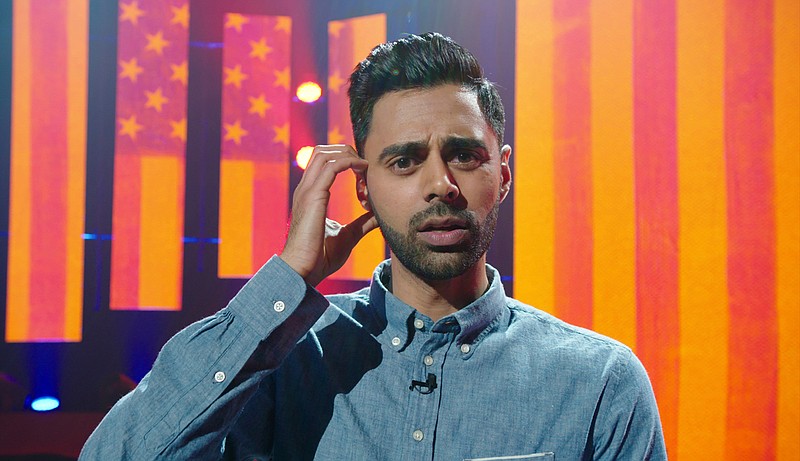 In this image released by Netflix, comedian Hasan Minhaj appears in a scene from his Netflix special, "Homecoming King." Minhaj is kicking off a 16-city North American tour starting in August and this fall will host his own weekly comedy show for Netflix. (Netflix via AP)