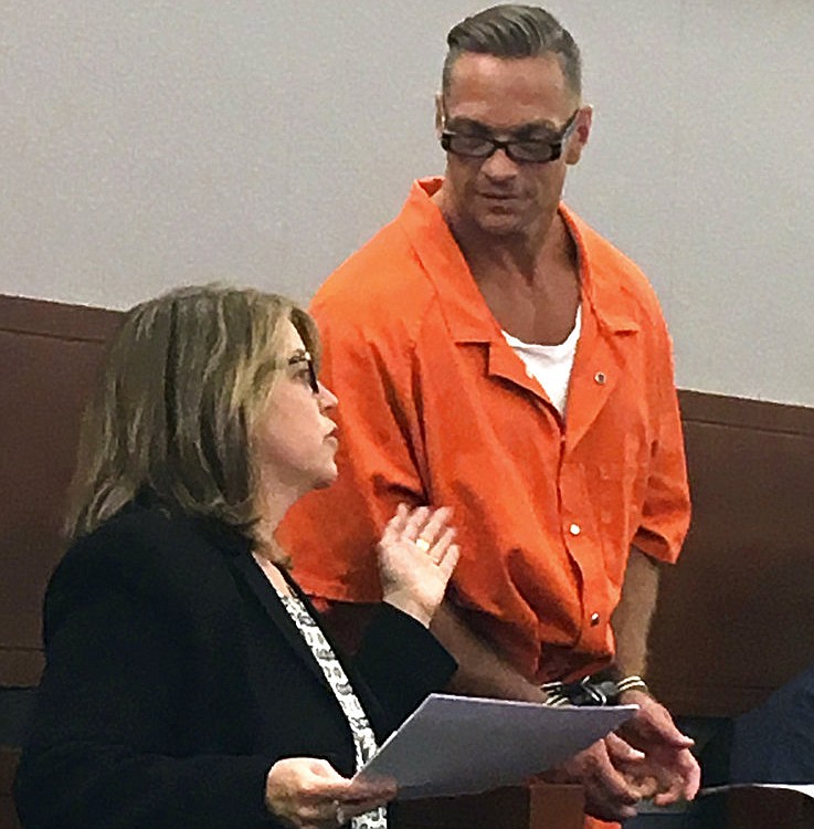 In this Aug. 17, 2017, file photo, Nevada death row inmate Scott Dozier, right, confers with Lori Teicher, a federal public defender involved in his case, during an appearance in Clark County District Court in Las Vegas. 