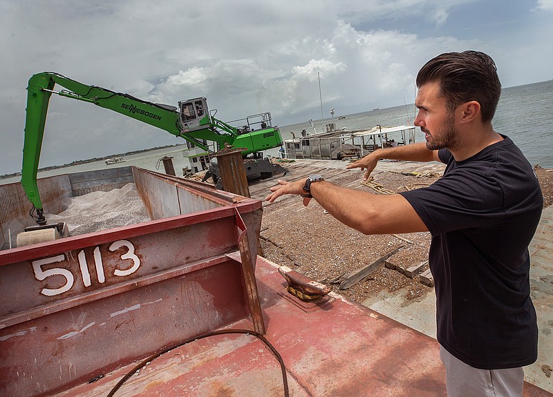 In this Monday, July 9, 2018 photo, Raz Halili, vice president of Prestige Oysters, describes the oyster reef building process in Galveston Bay near San Leon, Texas. The company is currently using tons of limestone to create a new reef. (Stuart Villanueva/The Galveston County Daily News via AP)