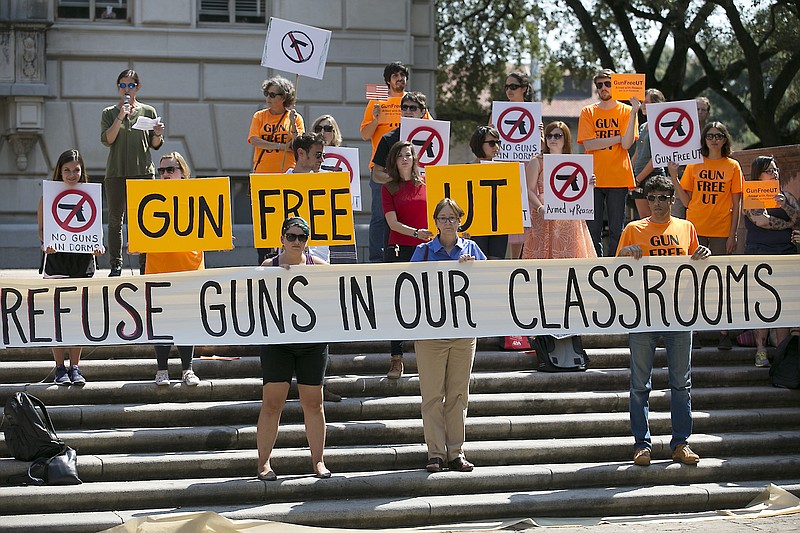 In this Oct. 1, 2015, file photo, protesters gather on the West Mall of the University of Texas campus, in Austin, to oppose a new state law that expands the rights of concealed handgun license holders to carry their weapons on public college campuses and as of Aug. 1, 2016, they can carry in campus buildings.